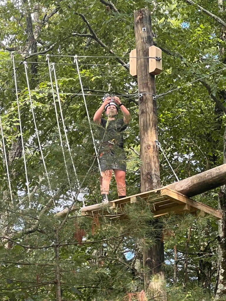 A camper on a ropes course.