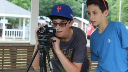 Two campers filming with a camcorder.