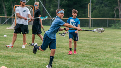 Campers playing lacrosse.