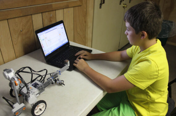 A camper working on a robotics project.
